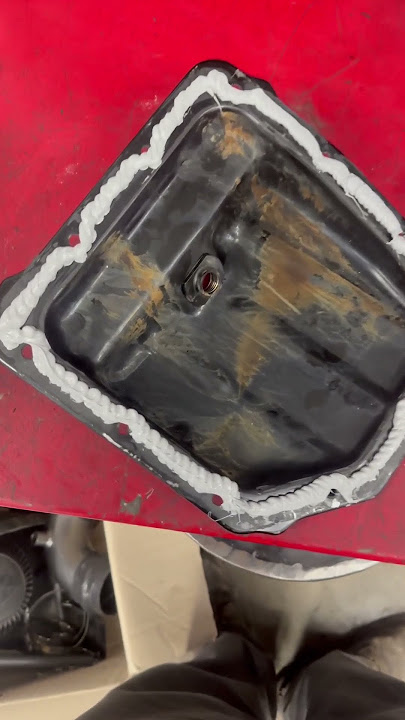 Applying RTV gasket maker and stacking dimes with it! #mechanic #rtv #silicone #oilpan #reseal #kg