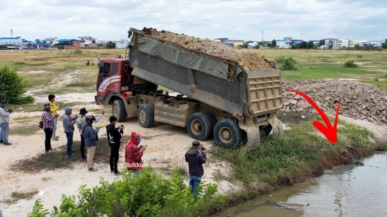 Excellent !! New work By heavy dump truck 25Ton unloading soil landfilling with bulldozer pushing 
