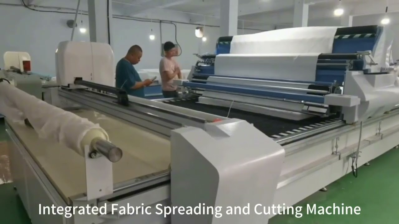 Integrated fabric spreading and cutting machine.