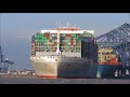 Strong SW winds batter Felixstowe as the OOCL United Kingdom departs with 3 tugs. 22nd November 2017