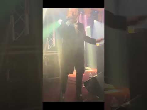 Mesmerizing Slow-Motion Performance by Men in Black Coast on Stage./