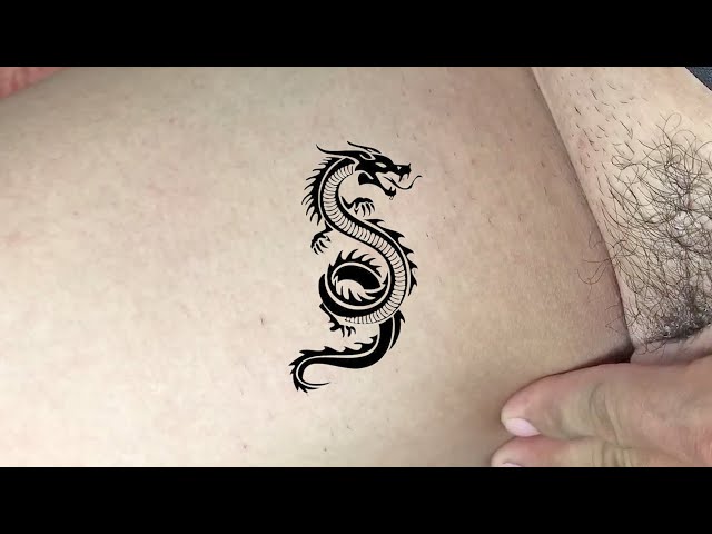 Single needle dragon tattoo on the inner forearm.