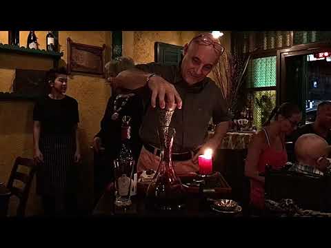 Owner Giovanni decants wine for our table at La Gaetana- Phuket, Thailand