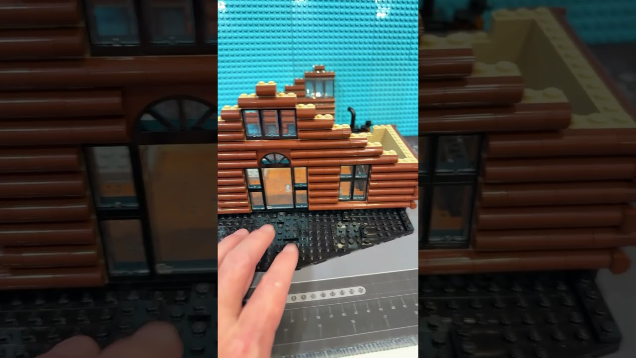 LEGO log cabin under construction. 
