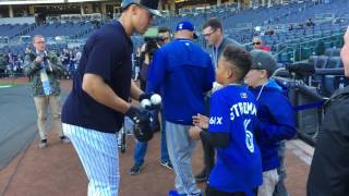 Aaron Judge signs an autograph for Marcus Stroman's little brother