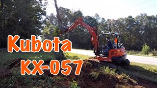 Knocking down trees and digging up stumps with a Kubota KX057