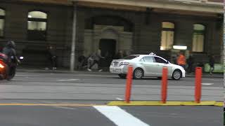 Silver top taxi does a U-turn Flinders St