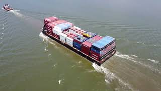 Container barge being pulled up the Delaware River