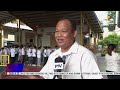 Security guards check bags of students entering the Batasan National High School; school...