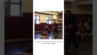 Little boy tries to protect her sister during a wrestling match ?