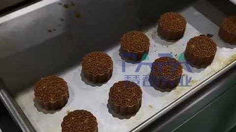 Automatic maamoul encrusting stamping and tray arranging machine