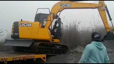 Jcb js 81 new machine unloading from trailer