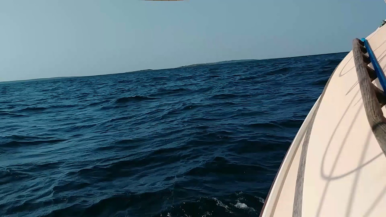 Herreshoff America Catboat hitting the waves off the Elizabeth Islands.