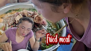 Mom and her kids eat fried Lao meat