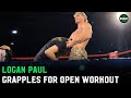 Logan Paul locks in a guillotine and grapples during open workouts