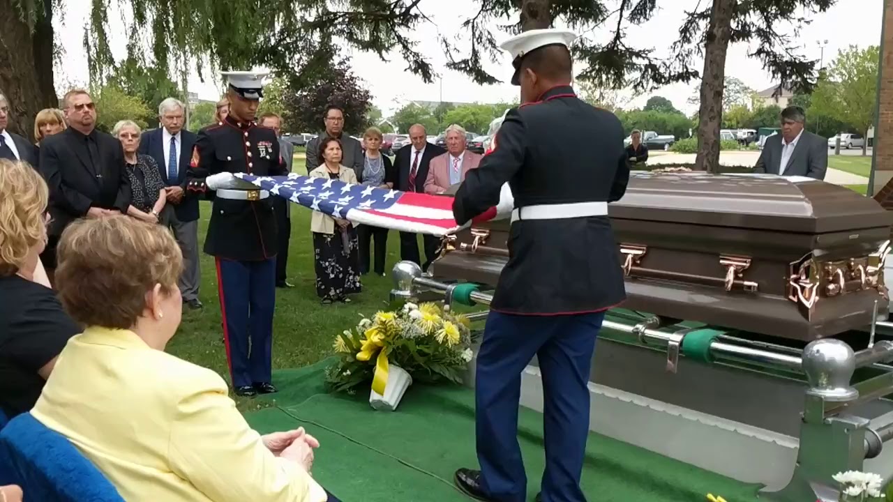 presentation of flag to family kneeling