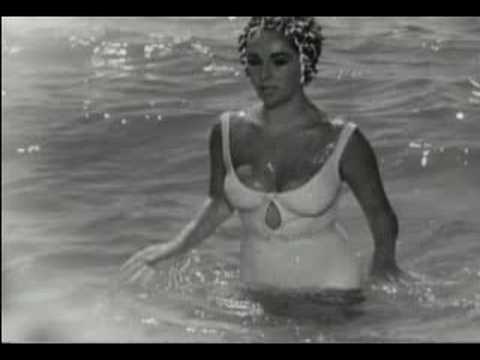 Liz Taylor In Lovely Loose Swimsuit At The Beach