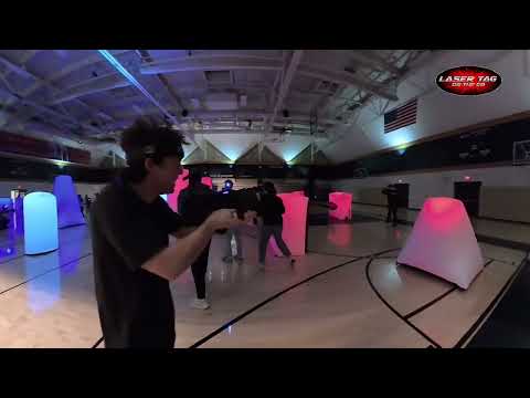 Laser Tag On The Go Glow Course with illuminated red and blue inflatable bunkers at night
