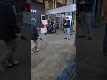 Jesse Affleck debating a young man by the street in front of Anvil Centre