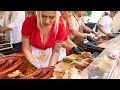 Street food in bucharest romania girls prepare sandwiches stuffed with sausage and meat