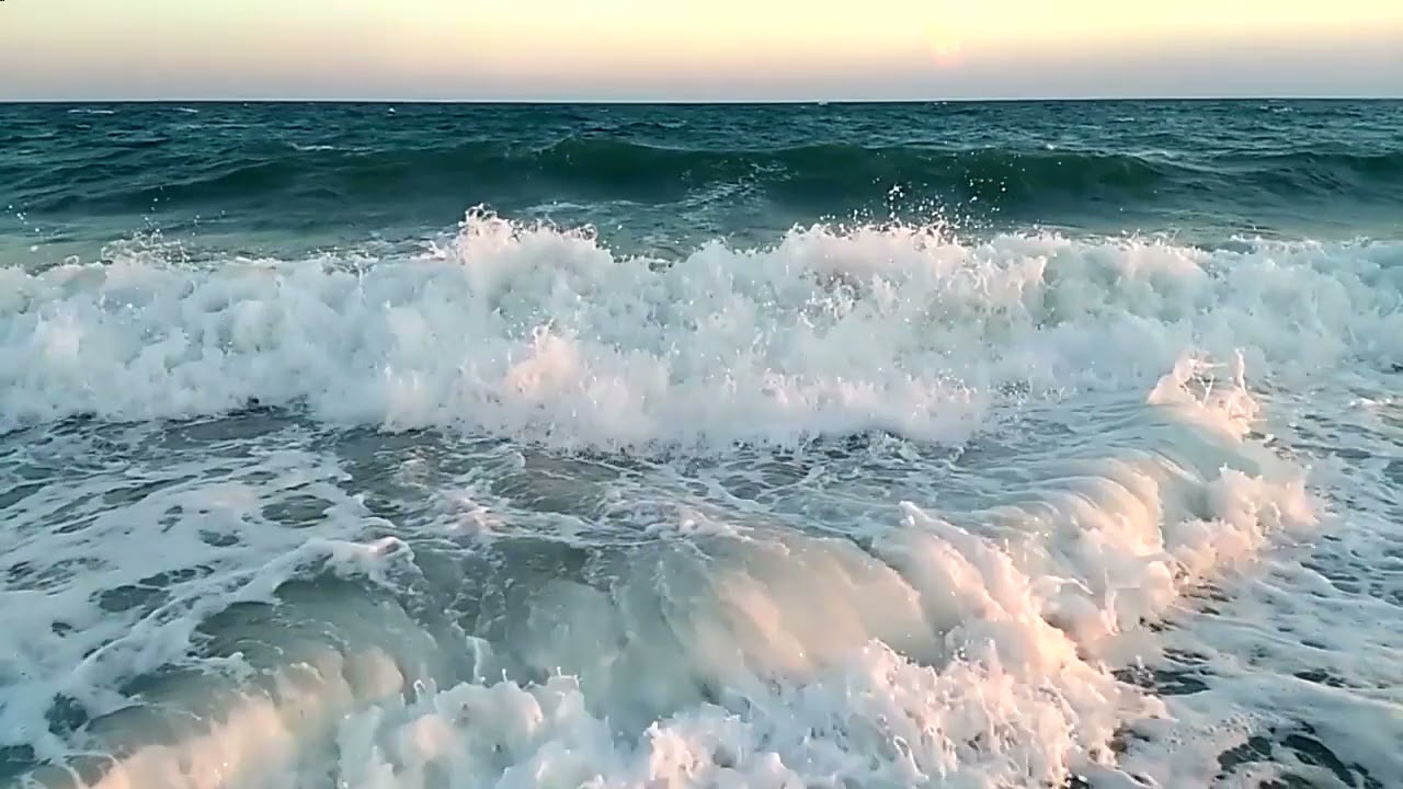 Beautiful sounds of the ocean waves crashing against the beach.