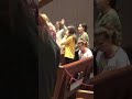 Little girl quietly performs the Macarena during church prayer