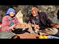 Old couple lovers in the cave cooking traditional sheeps liver  afghanistan village life