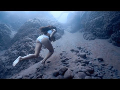 Freediver Carries Heavy Rock Across Ocean Floor