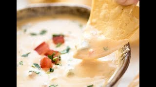 Code cracked: made with real cheese, this queso is silky smooth when
warm and at room temp. miracle!
http://www.recipetineats.com/queso-dip-mexican-cheese-dip/