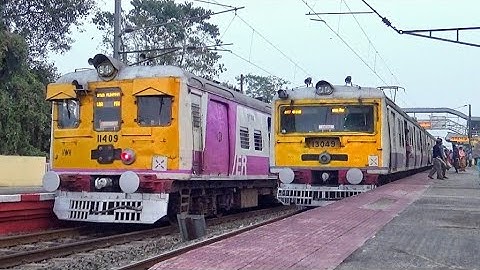 Different model purple color conventional EMU local train parallel crossing at Balagarh