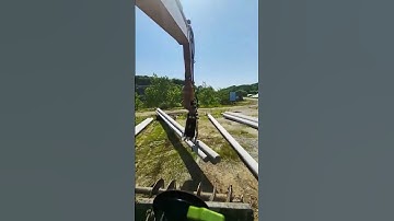 Process of excavators transporting utility poles