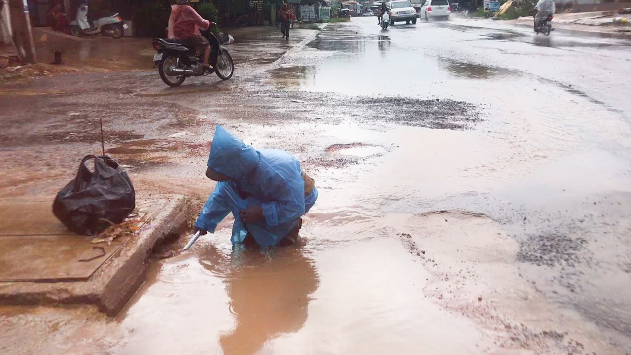 Unclogging Culvert Drains On Street Stuck Drain After A Heavy Rain ...