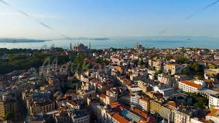 Istanbul, Turkey. Hagia Sophia and Blue Mosque aerial view with Fatih district rooftops under cle...