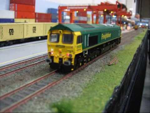 Here is my footage of the Model Railway Exhibition which was held on the 17th and the 18th of October 2009 at the East Of England Showground in Peterborough, United Kingdom. The video was taken on the 17 of October 2009 and this video has been split into three parts because of the 10 minute restriction on YouTube. All stills in this video have no sound and I have chosen NOT to include background music for legal and copyright reasons, but all video footage does have its original sound though. This video starts off with some stills of several new Hornby releases at their Hornby Stand which was located just inside the second hall. These incude the new EWS Management train which will feature the new MkIII DVT Model (although it is originally classed as a "DLV" which means "Driving Luggage Van" and not a DVT (Driving Van Trailer). Also there was the MkIII DLV in Virgin Trains livery and this model is numbered 82150 which will be available to buy as a stand alone model from December this year. Also in new releases there was the new Hornby Class 395 "Javelin" Model and two new Pullman VSOE carriages as well as some more DCC sound fitted models to expand the Hornby DCC Sound range like the Class 31, Class 50 and the 9F which sound quite impressive. The layouts shown here in this part of the video are Bishop Wearburn which is a classic steam based layout, Holland Park Intermodal Container Terminal.