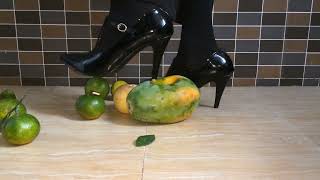 Strappy High Heels Trampling On Papaya Oranges