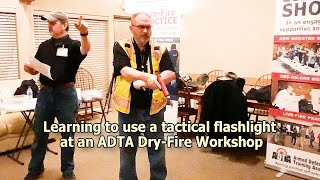 Learning to use a tactical flashlight at an ADTA Dry-Fire Workshop