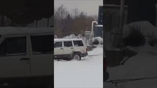 Oh no! Car stuck on tracks in the snow with train coming.