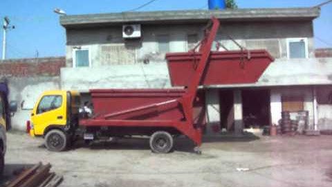 A Stacking skip from ground on skip on truck