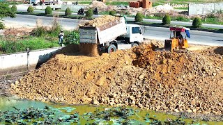 Just Starting New Project Filling Deep Pond Use Mini Dozer Spreading Stone Into Water & Trucks