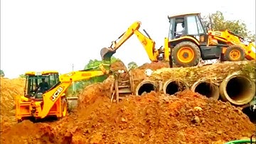 TWO JCB MACHINE WORKING ON BRIDGE CONSTRUCTION .