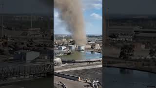 Person Filming a Whirling Dust Devil Wind While Working