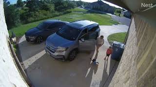 Little boy accidentally walks into car door as mom is opening it and bumps head (Security camera)