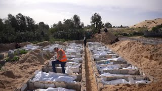 Remains of unidentified Palestinians are laid to rest at a mass burial site in central Gaza