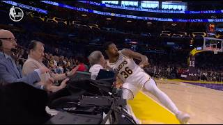 Marcus Smart hustles to save the ball and crashes into the monitors and Bill Maher