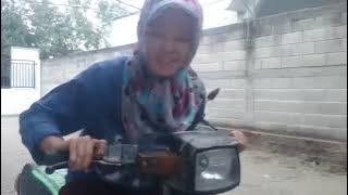 Young mother trying to start a two stroke curved beam motor