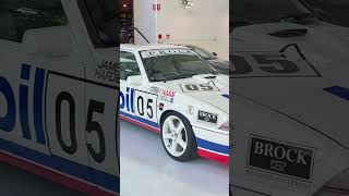 A Peter Brock VL group A Commodore in a showroom of expensive cars #supercars #v8supercars