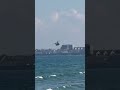 A military helicopter flying over the beach
