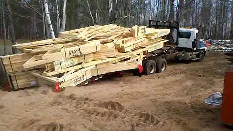 Unloading trusses at jobsite.