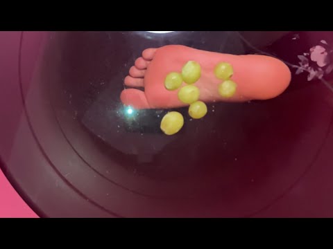 Crushing grapes barefooted