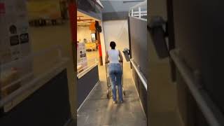 Woman Slips While Guiding Shopping Cart Down Ramp